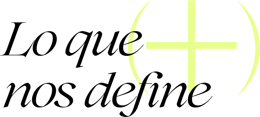 El texto en fuente elegante dice Lo que nos define en español, con un gran signo más amarillo pálido de fondo, parcialmente visible en el lado derecho. El fondo es gris claro.