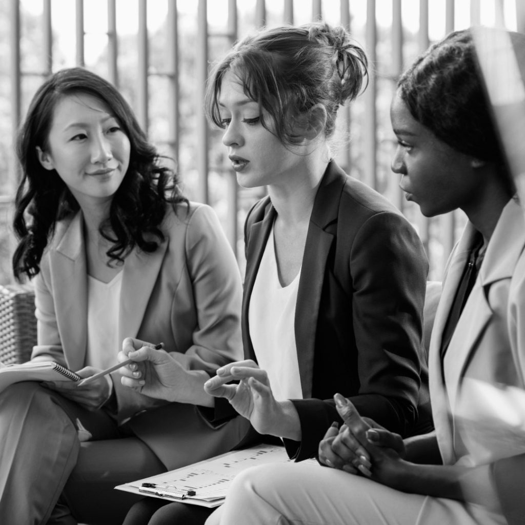 close up woman leading team meeting photoaidcom greyscale 1080x1080