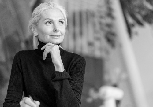 front view older woman working with pen photoaidcom greyscale 500x350