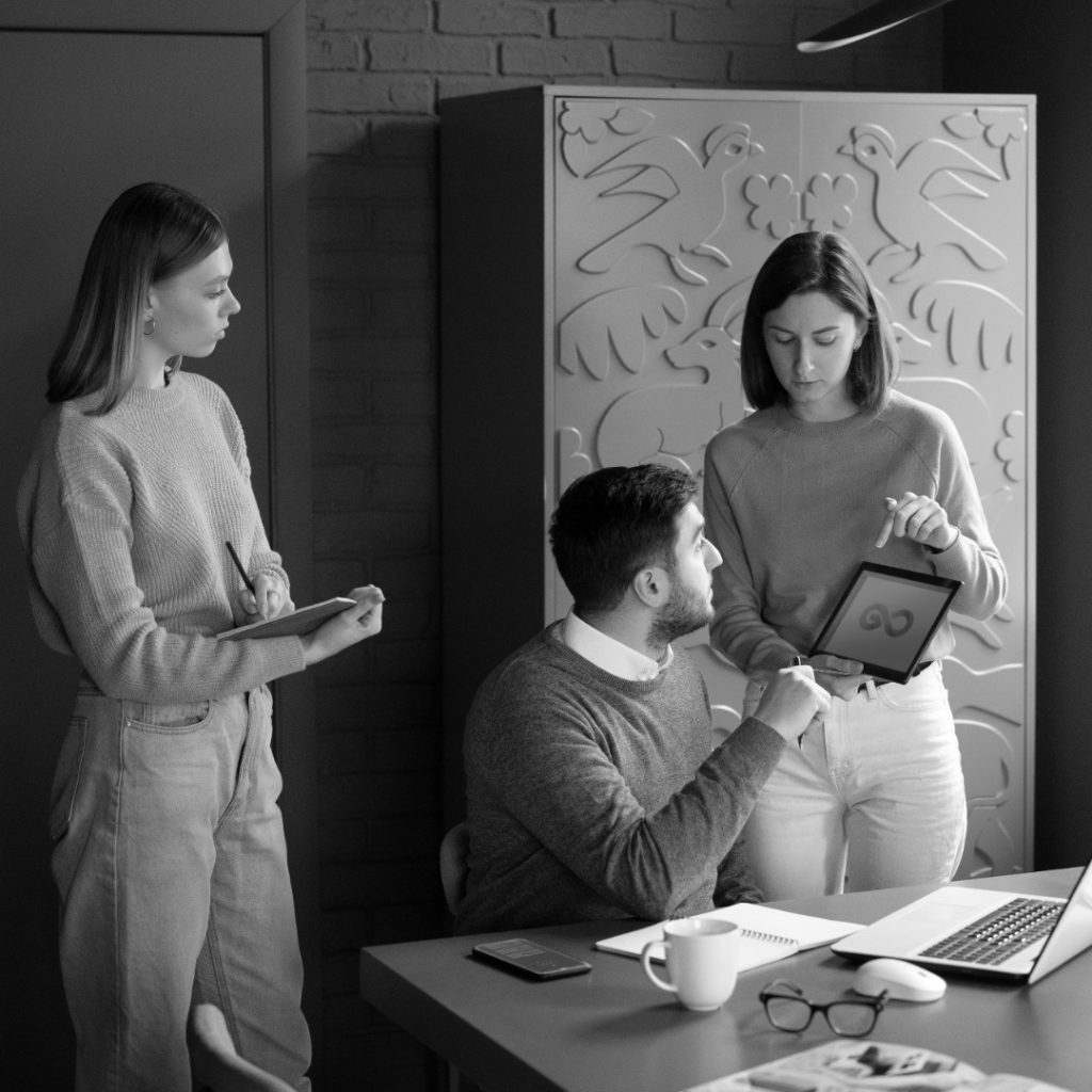 medium shot colleagues working photoaidcom greyscale 1080x1080