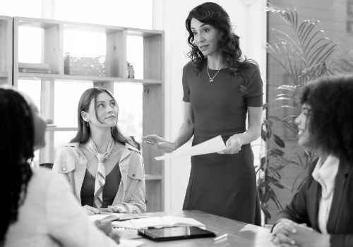 woman meeting document with team planning brainstorming review problem solving startup business people paperwork group with report proposal feedback creative agency photoaidcom greyscale 500x350